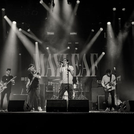 A custom backdrop with the name 'MAYLEAF' designed for a band, displayed at a concert stage with the band performing in front of it.