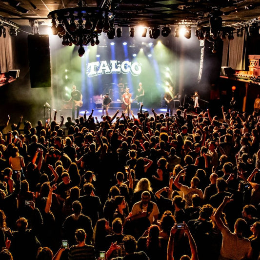 Custom backdrop for bands displayed at a live concert stage with the band 'Talgo' performing in the background.